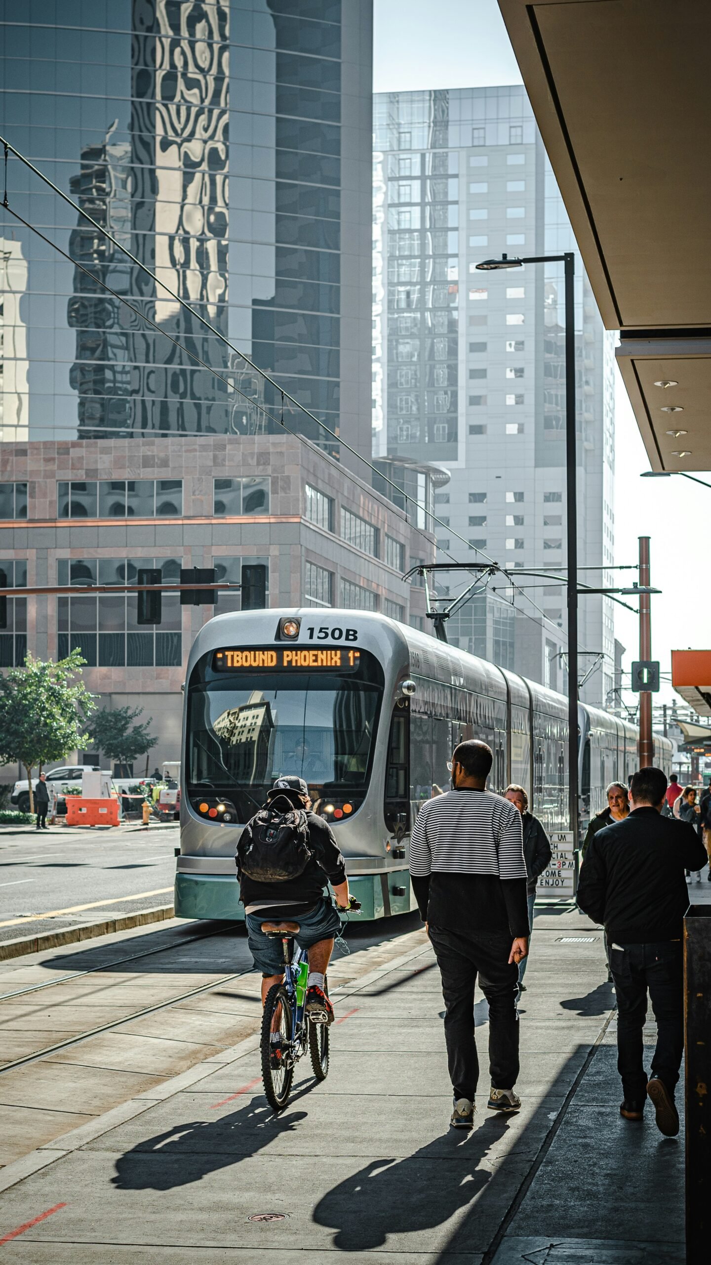 people walking on pedestrian lane near white and red train during daytime