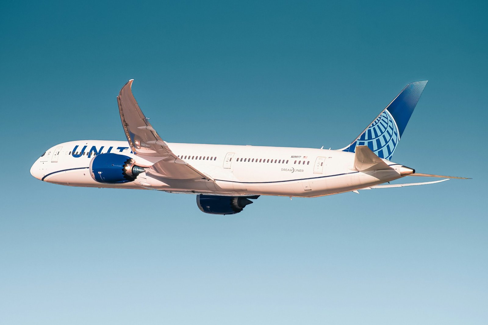 white and blue passenger plane in flight