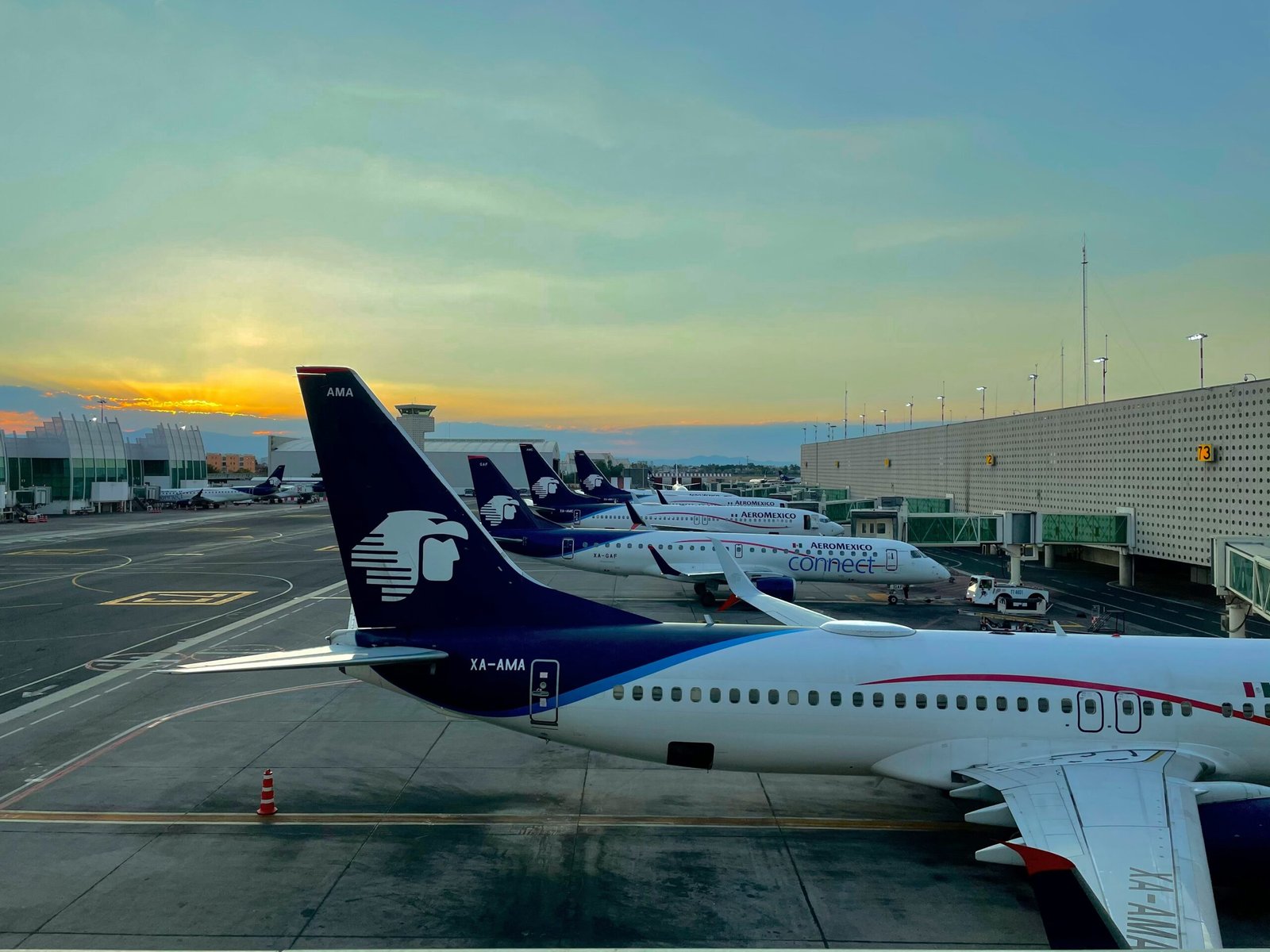 white and blue airplane on airport during daytime