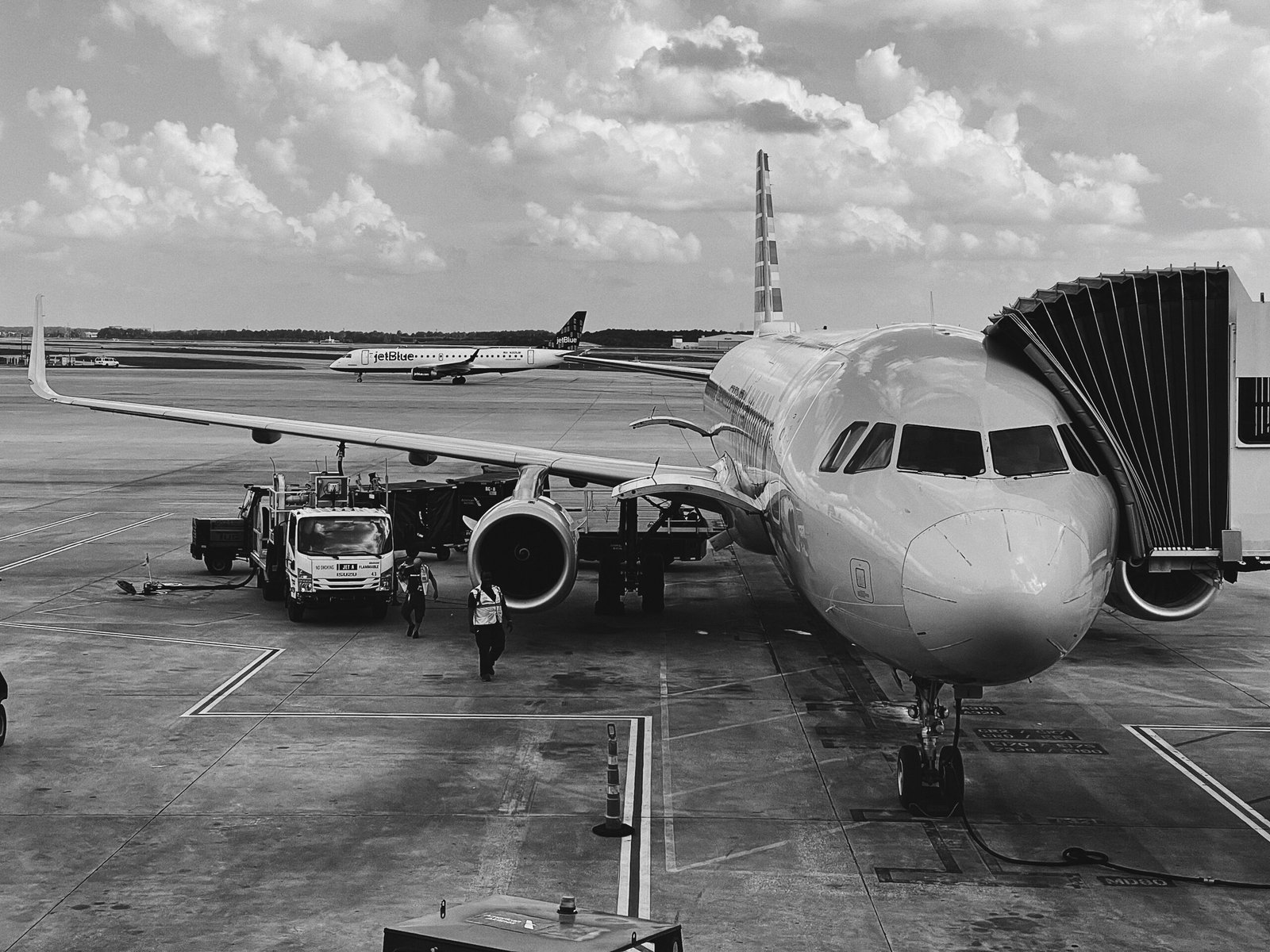 grayscale photo of airplane on airport