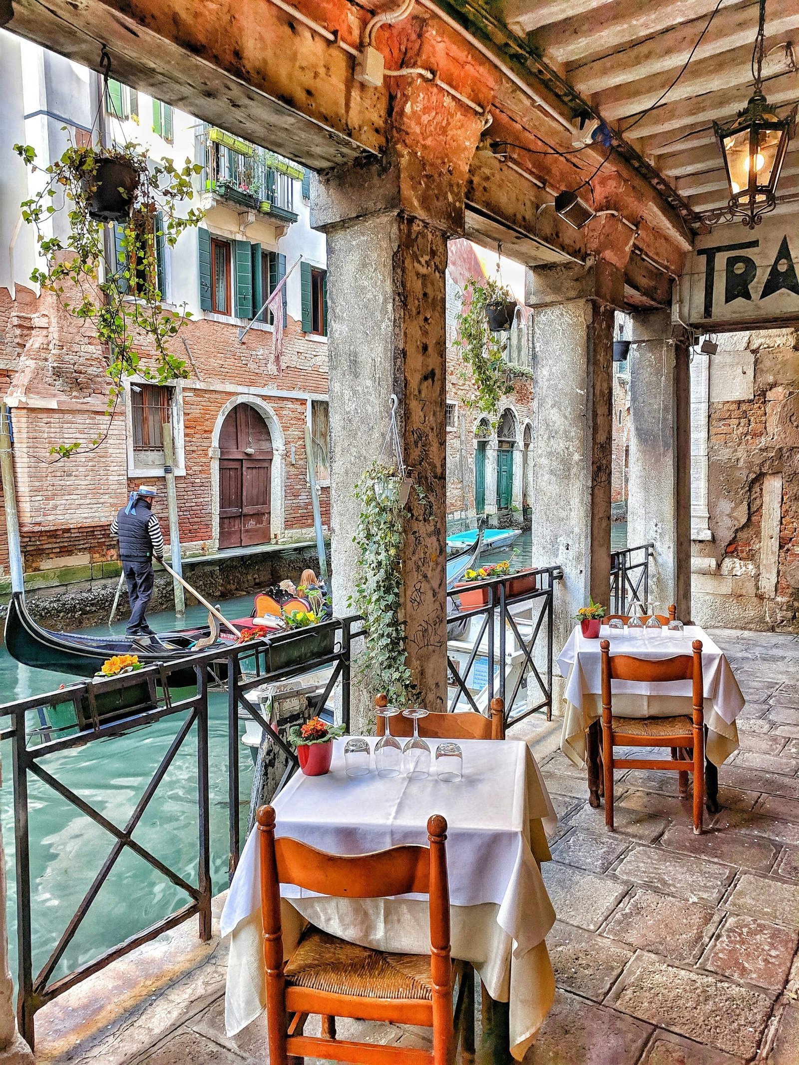 man riding on boat beside restaurant