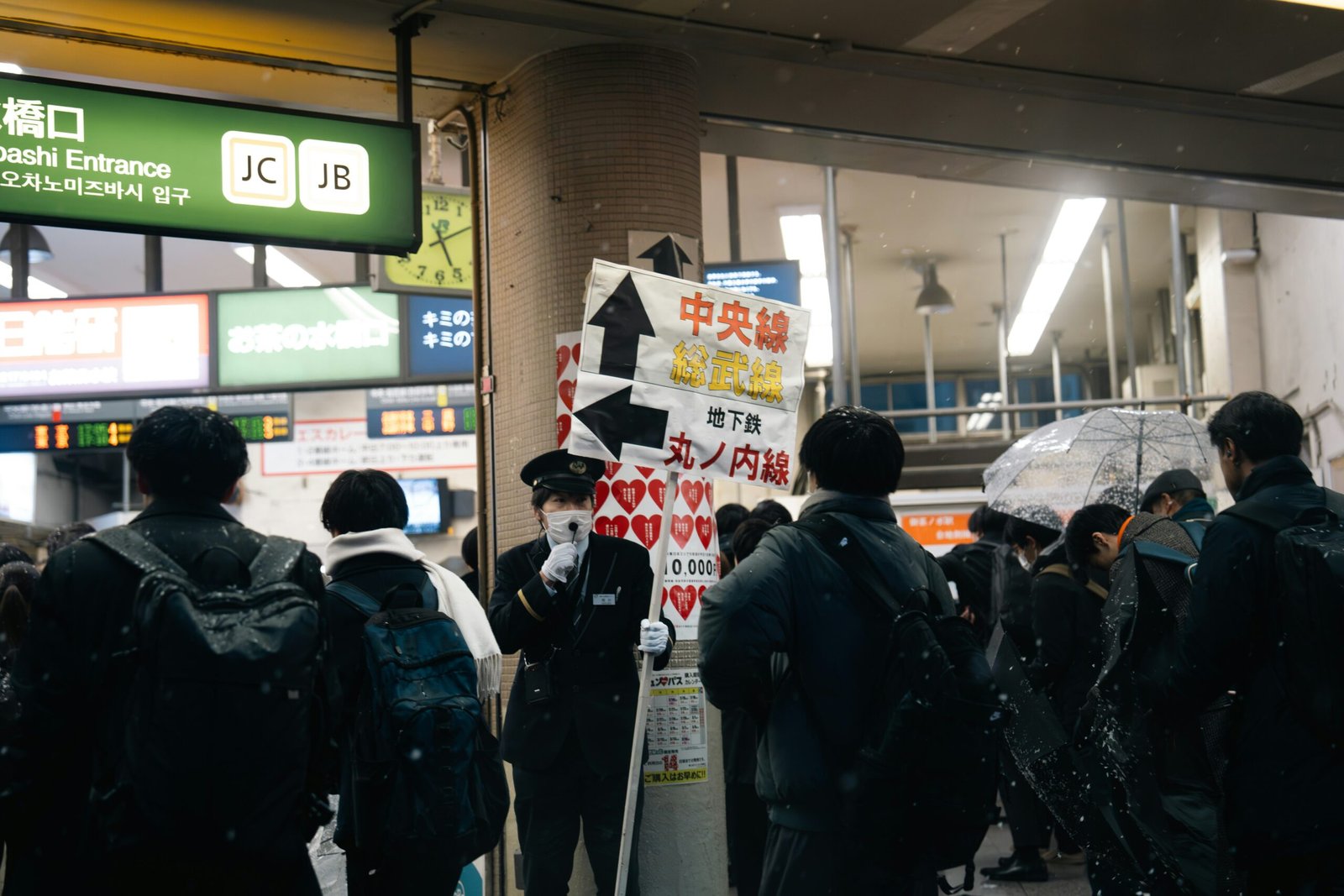 a group of people standing next to each other holding umbrellas